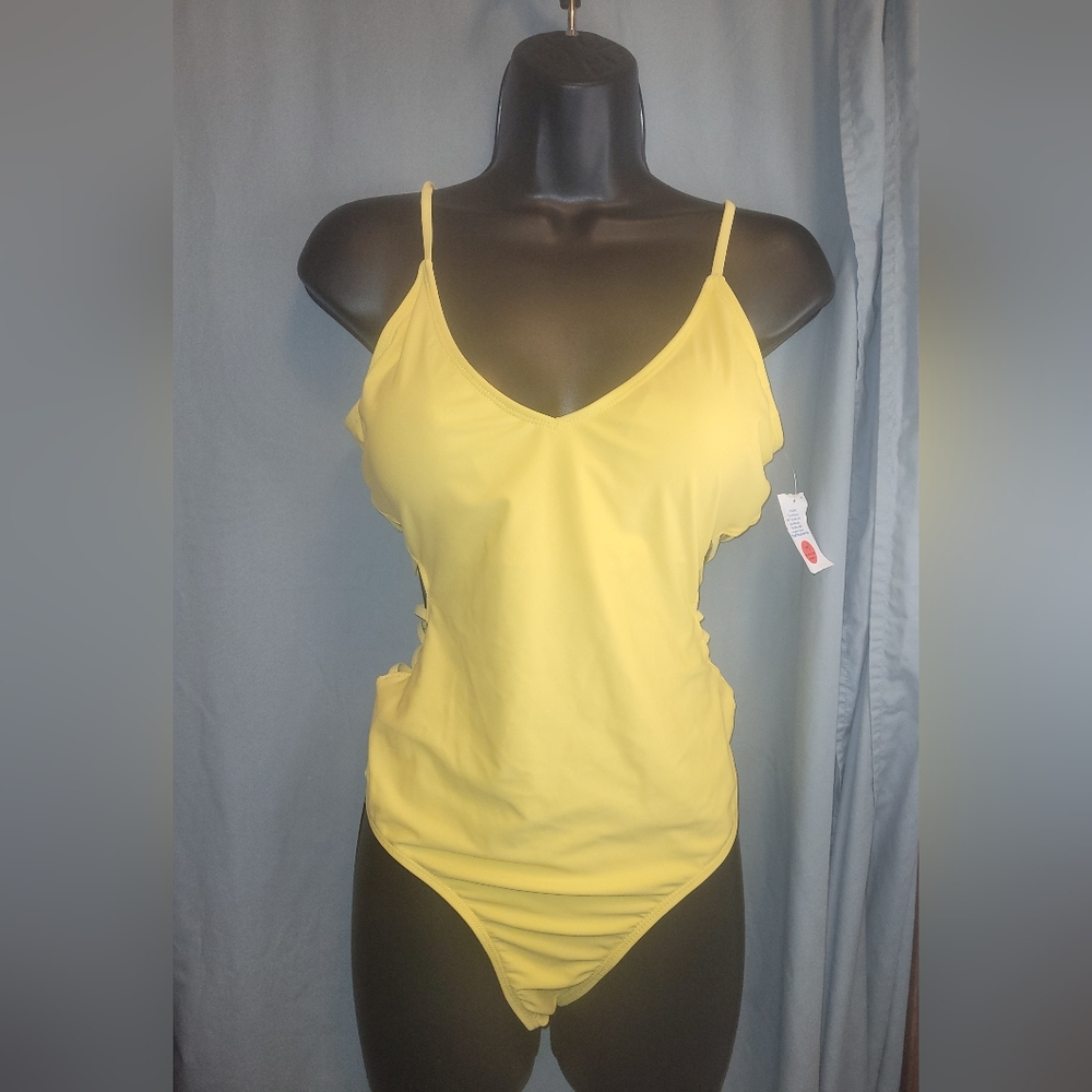 One-piece swimsuit featuring an open back and cut-out string sides. Size XL.